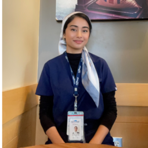 A female Spectrum nurse posing with ID badge